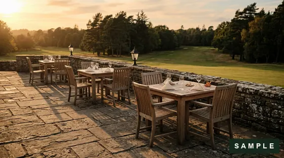Sample imagery: an empty stone terrace with teak tables overlooking a lawn - to be replaced by the club's photography.